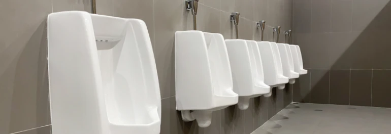  Una fila de urinarios blancos en un baño público. 