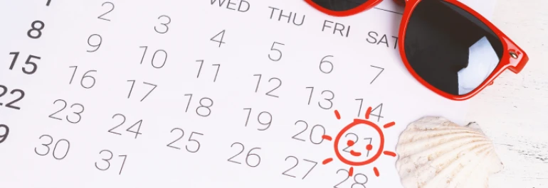  Un calendario con el día 21 marcado, acompañado de unas gafas de sol y una concha. 