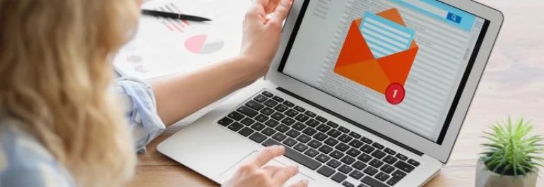  Una persona está usando una laptop con una pantalla que muestra un ícono de correo electrónico. 